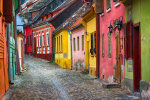 romania colourful street buildings cobbled roads